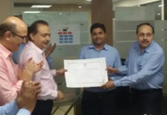 Prism Johnson employees presenting a certificate during an office award and recognition ceremony
