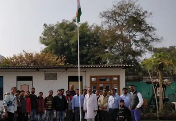 Prism Johnson employees participating in a flag hoisting ceremony outside the office building