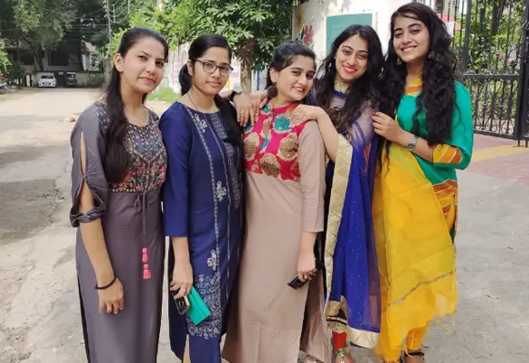 Women employees of Prism Johnson Limited posing together during a cultural celebration